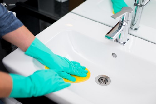 Professional cleaner discussing cancellation and scheduling terms